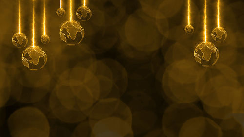 Close-up of illuminated lighting equipment hanging at night