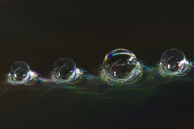 Close-up of illuminated lights over black background