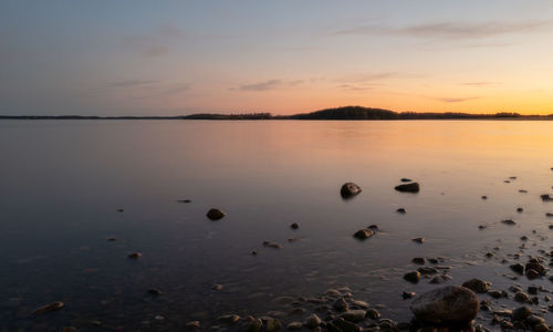 Scenic view of lake against sky during sunset