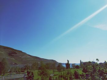 Scenic view of mountains against blue sky