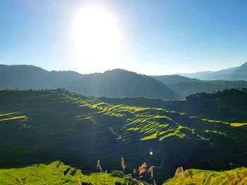 Scenic view of mountains against sky on sunny day