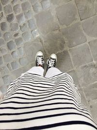 Low section of woman standing on tiled floor