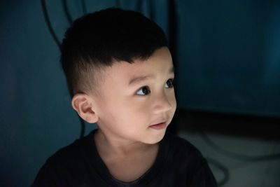 Portrait of boy looking away at home