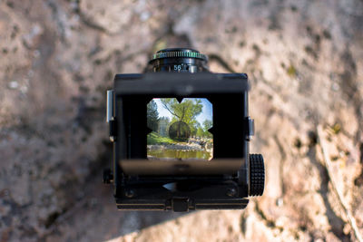 Close-up of vintage camera on rock