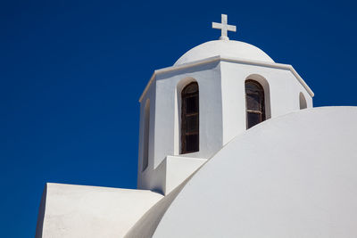 Low angle view of white building against clear blue sky