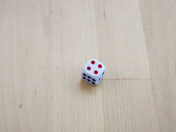 High angle view of dice on hardwood floor at home