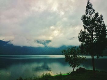 Scenic view of calm lake against cloudy sky