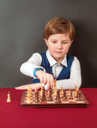 Portrait of boy playing chess