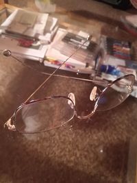 Close-up of sunglasses on glass table