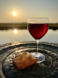 Close-up of wineglass on table with a cookie