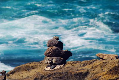 Rocks stacked against sea