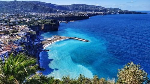 High angle view of bay against clear blue sky