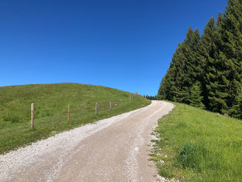 Empty road along countryside landscape