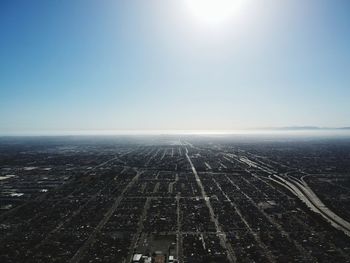 Aerial view of landscape against clear sky on sunny day