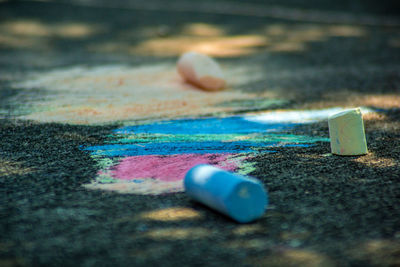 Close-up of multi colored pencils on road