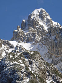 Scenic view of snowcapped mountains against clear blue sky