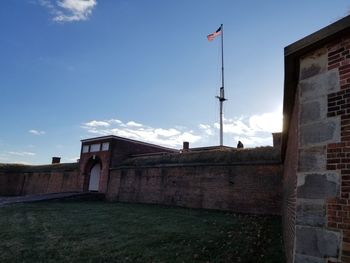 Low angle view of flag against sky