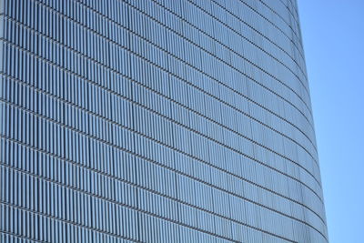 Low angle view of modern building against clear blue sky