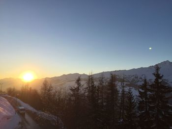 Scenic view of mountains against clear sky during sunset