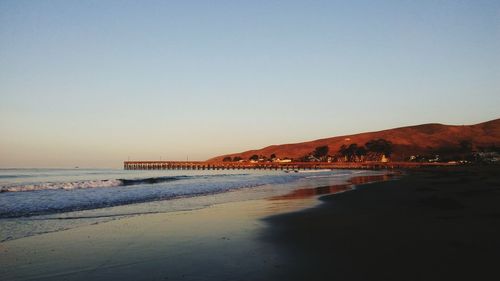 Scenic view of beach against clear sky