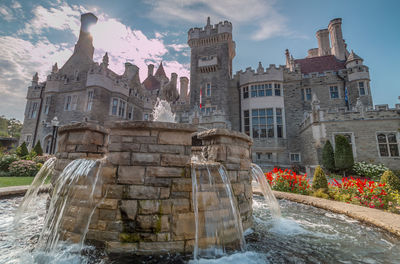 Water fountain against historic building