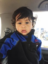 Portrait of cute boy in car