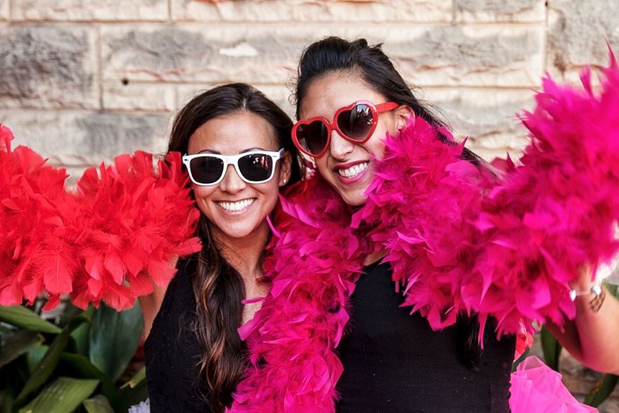 lifestyles, looking at camera, portrait, flower, person, young adult, leisure activity, young women, front view, smiling, pink color, sunglasses, casual clothing, headshot, happiness, freshness, holding, sitting