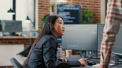 Businesswoman talking with colleague in office