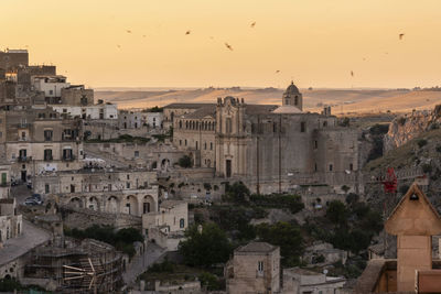 Buildings in city at sunset