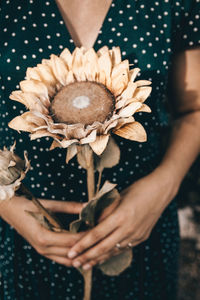 Midsection of woman holding bouquet