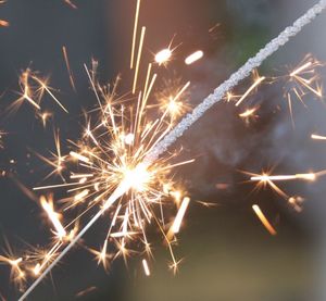 Low angle view of firework display at night