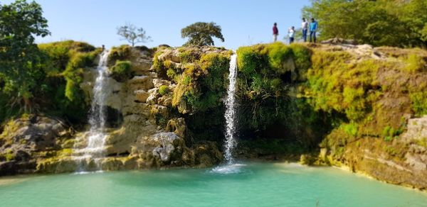 Scenic view of waterfall against sky