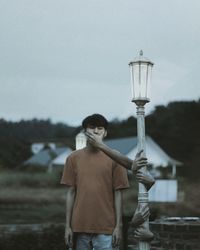 Rear view of man standing against sky