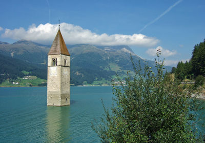 The bell tower of the former church of curon venosta in lake resia, south tyrol, italy.