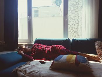 Man sleeping on bed at home