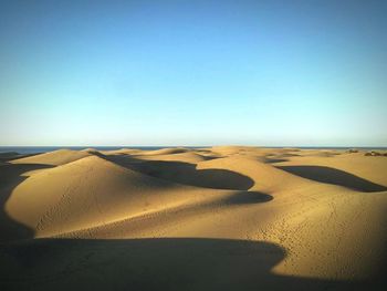 Scenic view of desert against clear sky