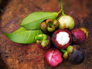 High angle view of fruits and leaves on table