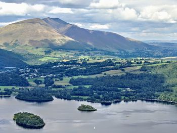 Scenic view of river and mountains against sky