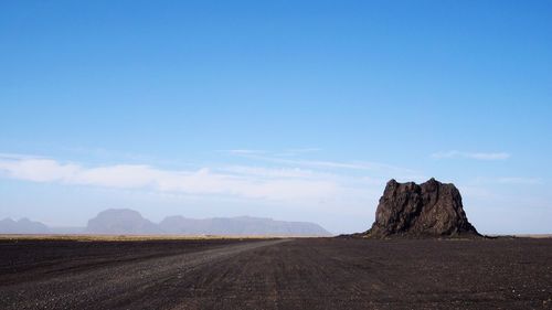 Scenic view of landscape against blue sky