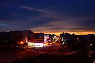 Illuminated cityscape against sky at night