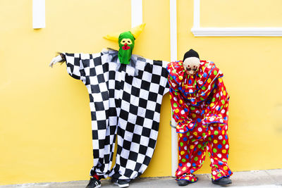 Two people wearing carnival mask