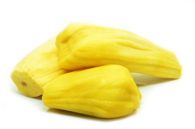 Close-up of yellow slices over white background