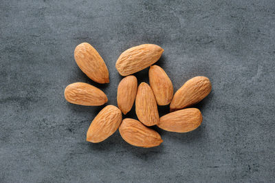 Close-up of almonds  against gray background