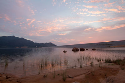 Scenic view of beach against sky during sunset