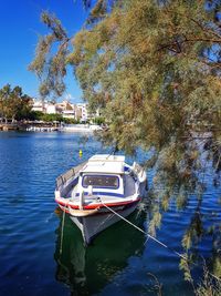 Boat moored on lake against clear sky