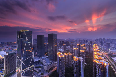 Aerial view of city lit up at sunset