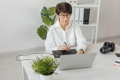 Female doctor working at table