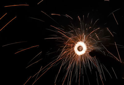 Low angle view of firework display at night
