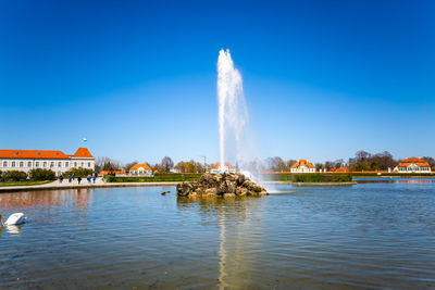 Panoramic view of lake against clear blue sky