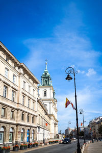 Low angle view of holy cross church by street in city